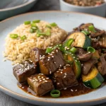 Hibachi steak recipe served on a cast iron skillet with fried rice and vegetables